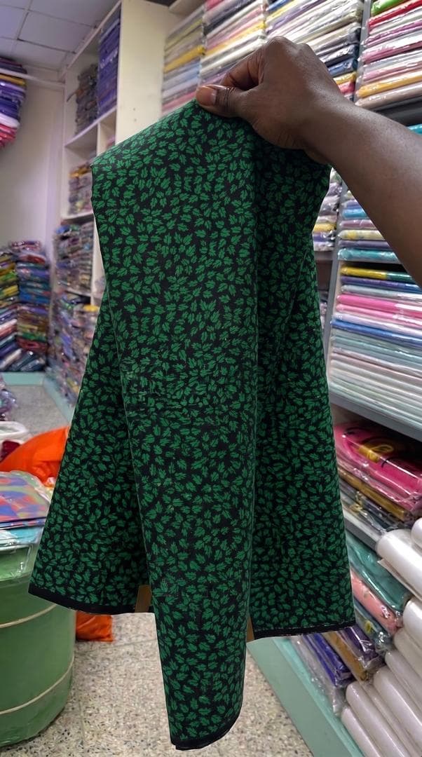 Green leaf print on black — styled as a dinner jacket — the fabric in stock at Zion Vitenge Centre