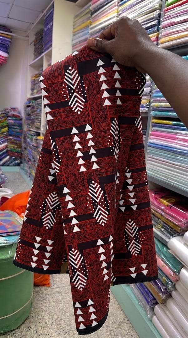 Red, black and white triangle print — styled as a long-sleeve shirt — the fabric in stock at Zion Vitenge Centre